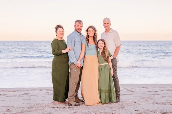 Family of five posing together on the beach at sunset in Melbourne Beach, Florida