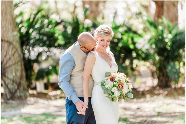 Groom kissing brides neck during a Up the Creek Farms Wedding